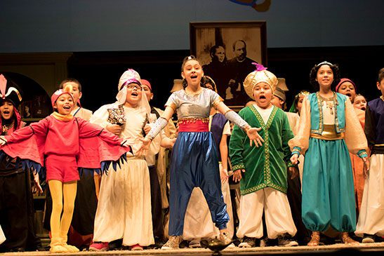 students performing aladdin on stage