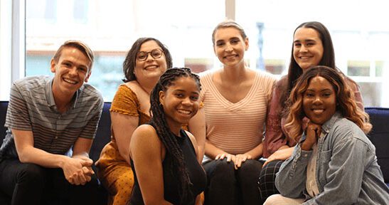 Young adults gather in group for photo