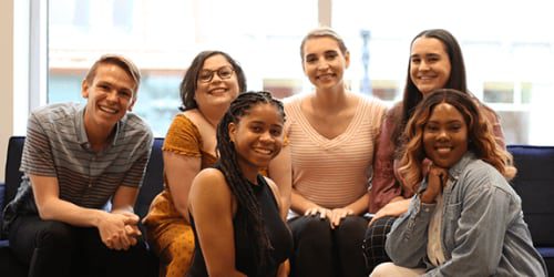 Young adults gather in group for photo