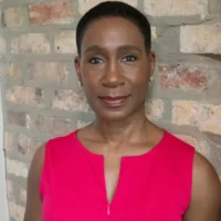 A woman in a pink shirt.