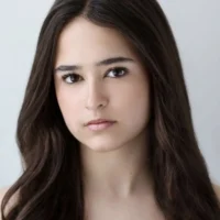 Headshot of a young woman with long dark hair looking directly at the camera.