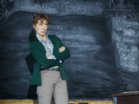 Schoolteacher with arms crossed and a surprised expression.