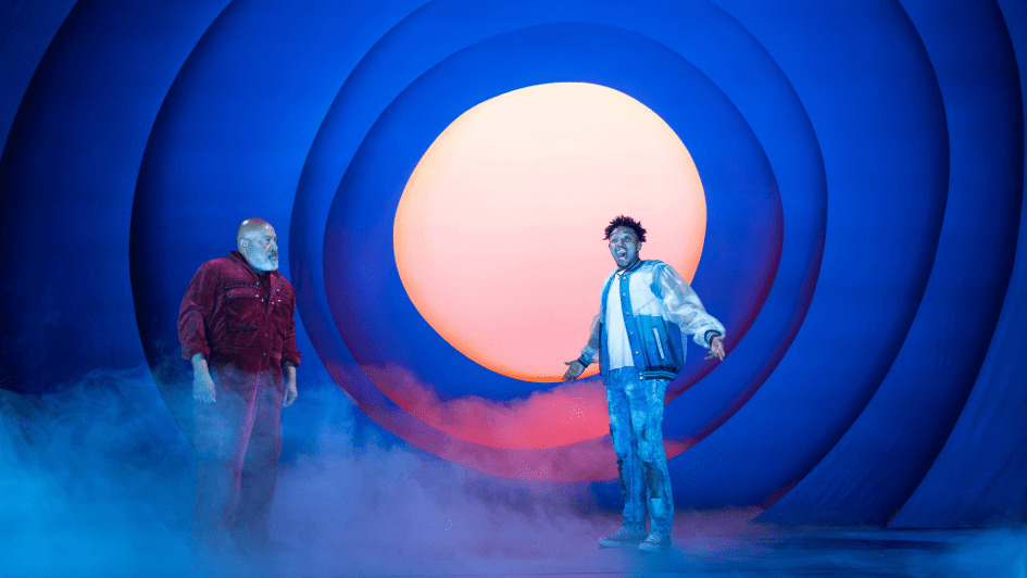 Two people looking surprised with a light orb and fog behind them,