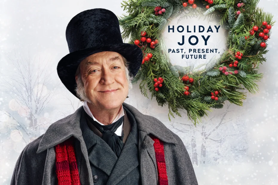 An older man in Victorian clothing and top hat stands in front of a holiday wreath with the text "Holiday Joy Past, Present, Future" on a snowy background.