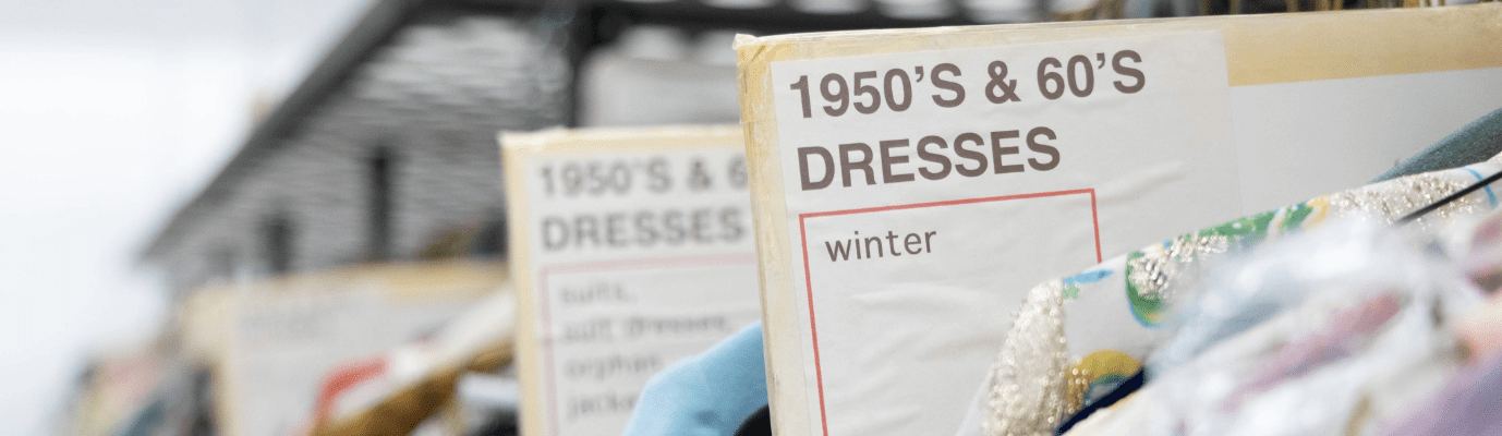 Rack of 1950's and '60's era winter dresses.