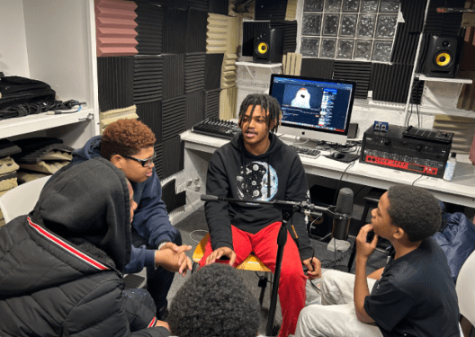 A group of teens in a recording studio.