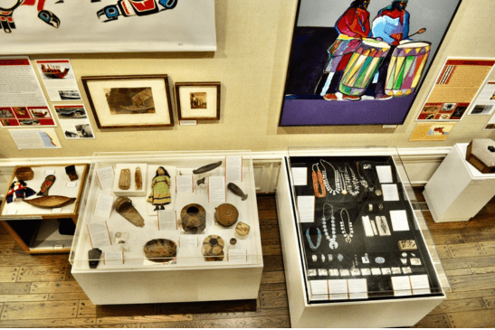 Various museum displays of Indigenous artwork, pottery, jewelry, and more.