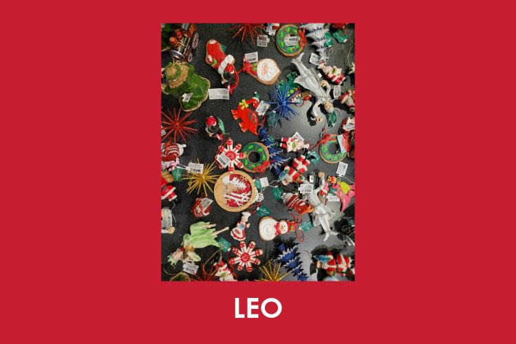 Assorted Christmas ornaments, including Santa figures, stars, and reindeer, are spread out on a dark surface. The word "LEO" appears at the bottom on a red background.