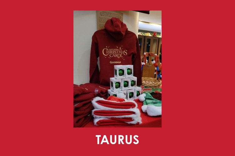 A display of red hoodies, Santa hats, and Christmas ornaments on a table, with "TAURUS" written in bold white letters below the image.