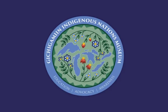 A circular logo for Gichigamiin Indigenous Nations Museum features floral designs and the Great Lakes, with “Education | Advocacy | Awareness” written along the border.